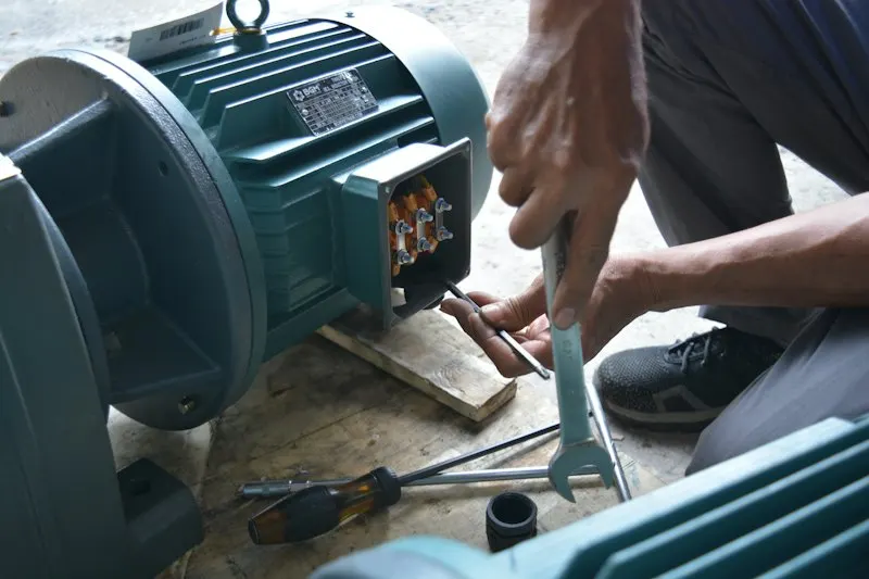 Technician working in a motor terminal box